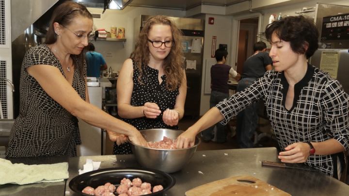 Dartmouth staff members, from left, Lisa Sharp Grady, Nicole Westervelt, and Alexandra Stein ’06 prepare dinner at the Upper Valley Haven.