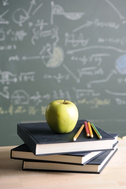 Books, apple, and chalkboard