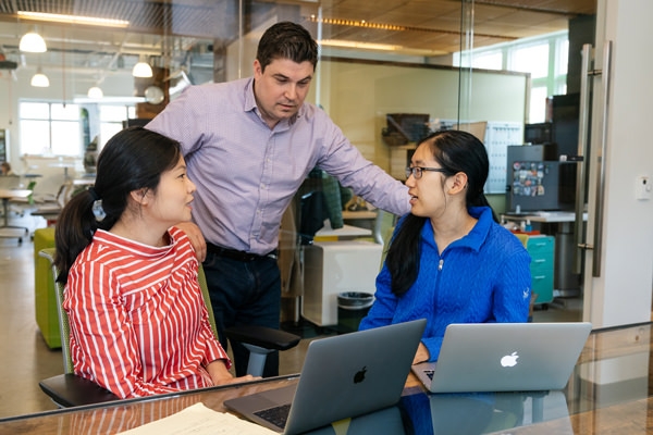 Jamie Coughlin, director of the Magnuson Center for Entrepreneurship, checks in with Annie Ren, program manager at the center and Sarah Hong ’21, a student leader at Magnuson, as they discuss a public event about venture capital.