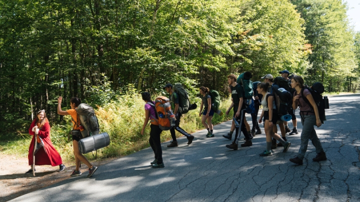 Vox Croo co-captain Daniela Armas '20, in character as a woodland spirit, intercepts a climbing trip as they cross a road.